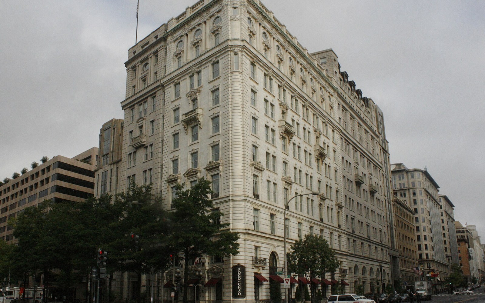 Ornate stone facade of a multistory corner building on a city street